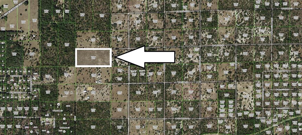 This is an aerial map showing a highlighted rectangular parcel of land — 5990 W OAKHILL STREET, DUNNELLON, FL