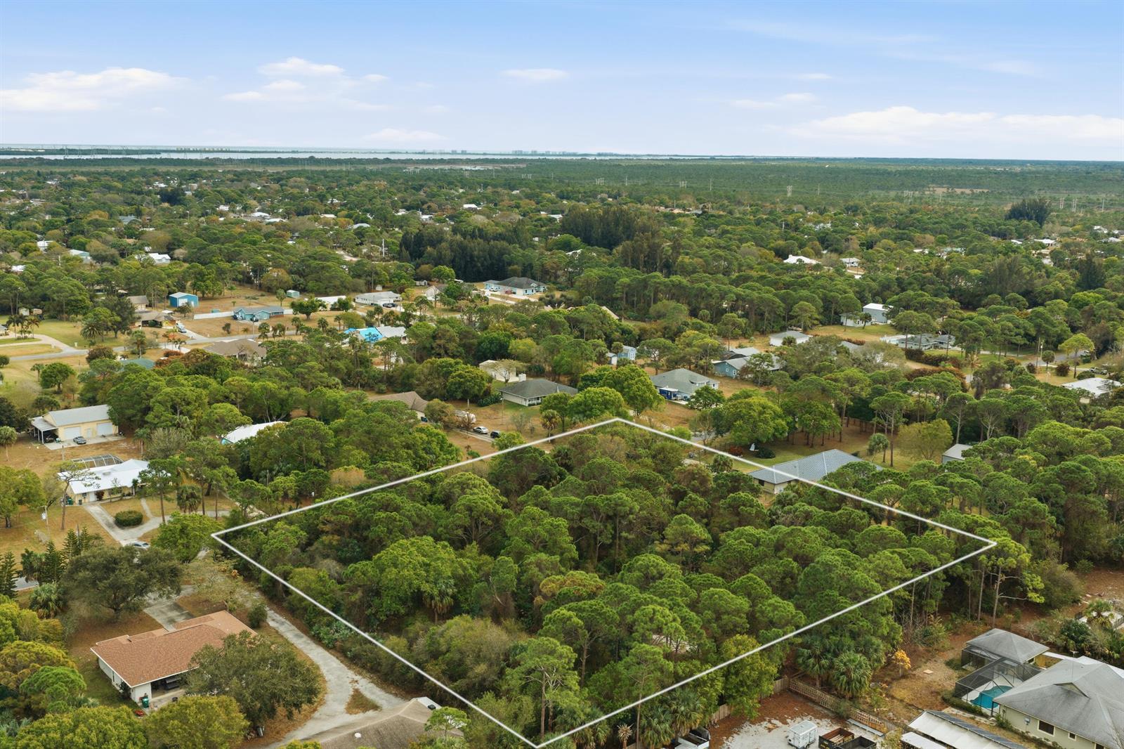 An aerial view shows a rectangular, tree-covered vacant lot outlined in white — 0 Pinetree Drive, Fort Pierce FL 34982, FORT PIERCE, FL