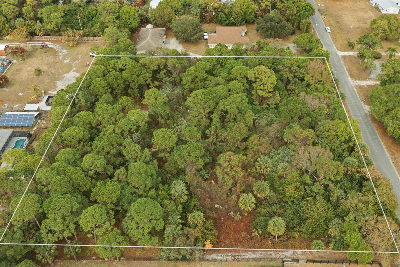 An aerial view shows a rectangular, tree-covered vacant lot outlined in white — 0 Pinetree Drive, Fort Pierce FL 34982, FORT PIERCE, FL