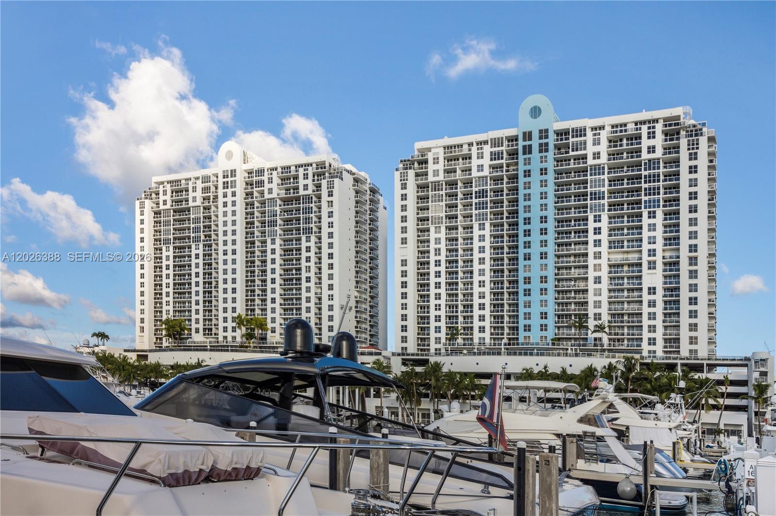 Two tall white residential buildings overlook a marina filled with docked yachts — 1800 Sunset Harbour # 1612, Miami Beach FL 33139, MIAMI BEACH, FL