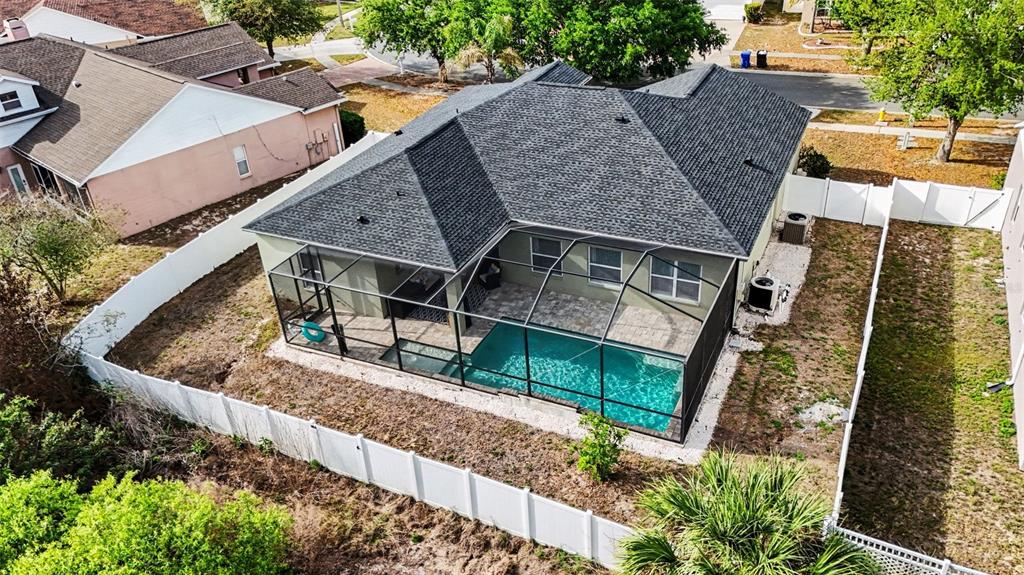 An aerial view of a house with a screened-in pool and a white vinyl fence — 9637 WYDELLA STREET STREET, RIVERVIEW, FL