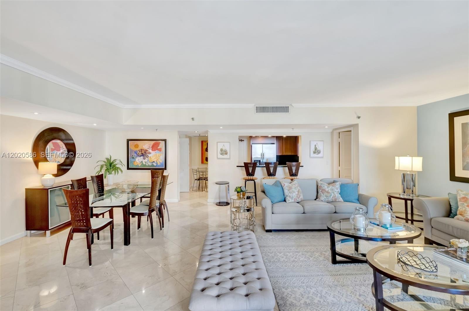 A living and dining area features tile flooring, a glass dining table, and neutral furniture — 520 Brickell Key Dr # A914, Miami FL 33131, MIAMI, FL