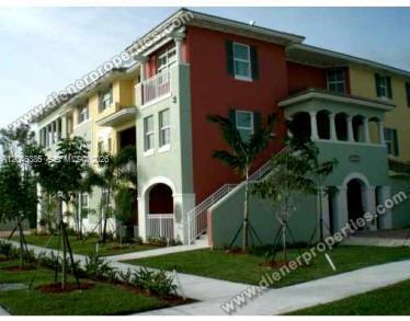 A three-story apartment building features a red and light green exterior with outdoor staircases — 11002 NW 83rd St # 215, Doral FL 33178, DORAL, FL