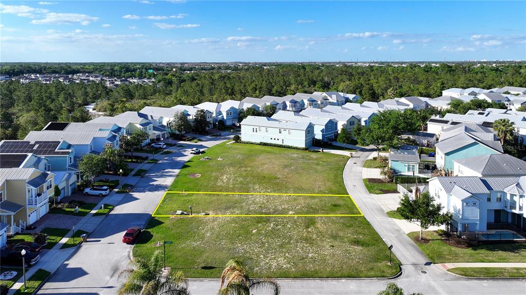 An aerial view shows a vacant rectangular lot outlined in yellow within a residential neighborhood — FAIRVIEW CIRCLE, KISSIMMEE, FL