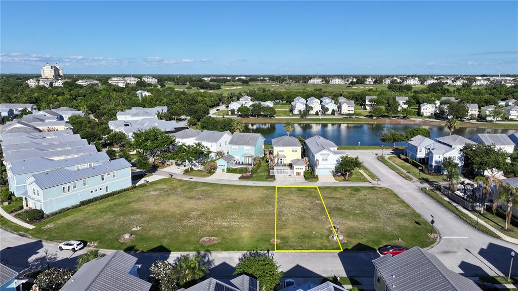 An aerial view shows a vacant residential lot outlined in yellow within a suburban neighborhood — FAIRVIEW CIRCLE, KISSIMMEE, FL