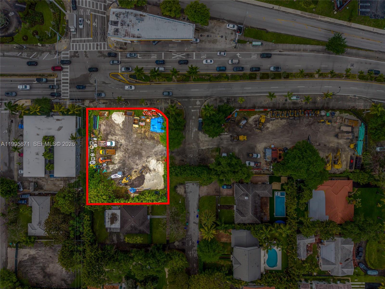 An aerial view shows a fenced, dirt-covered vacant lot situated next to residential properties — 5445 & 5501 Biscayne Blvd, Miami FL 33137, MIAMI, FL