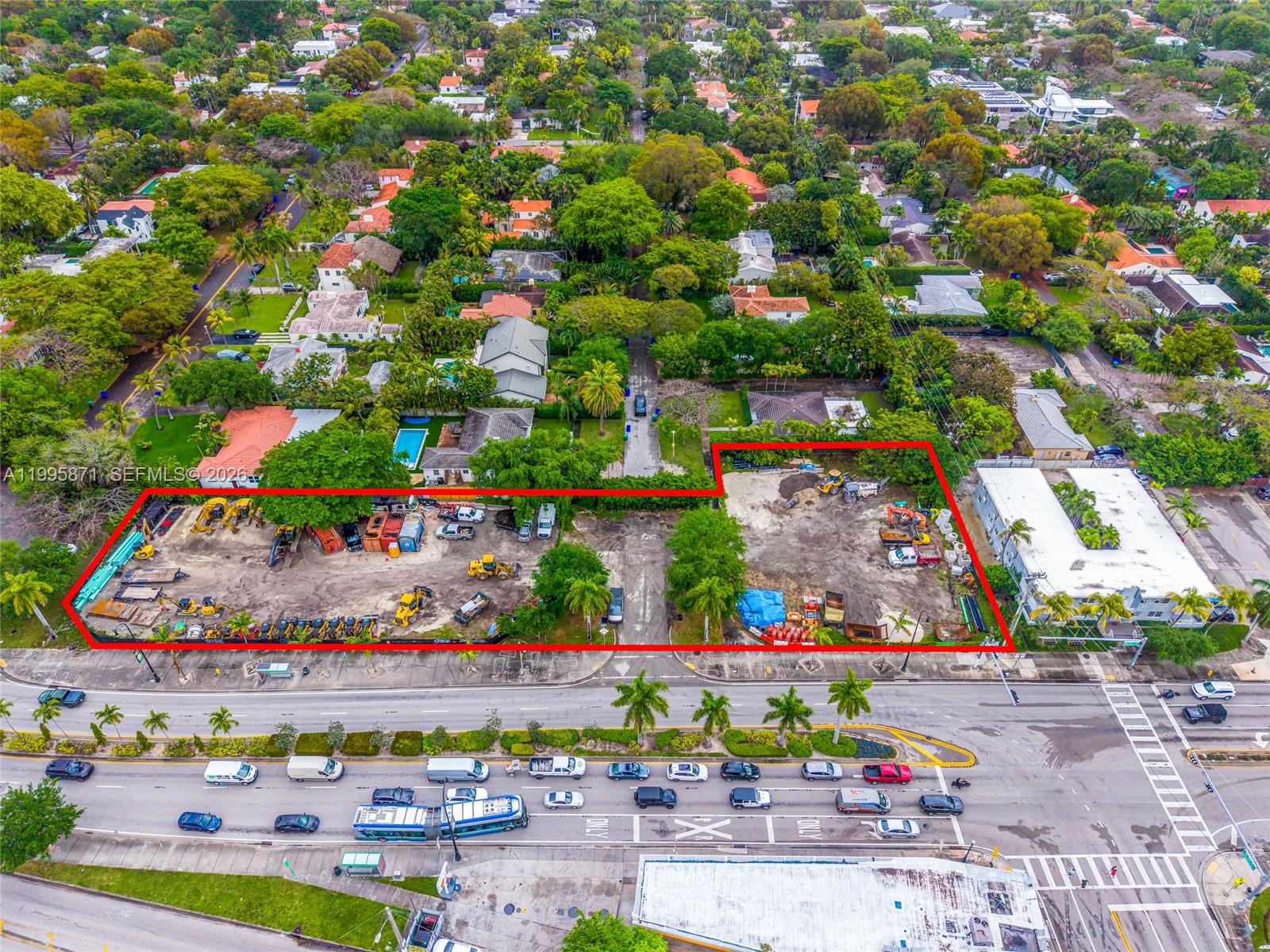 An aerial view shows a vacant, fenced-in construction lot situated along a busy multi-lane road — 5445 & 5501 Biscayne Blvd, Miami FL 33137, MIAMI, FL