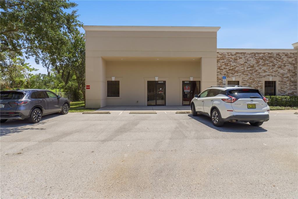 A commercial building exterior with two glass entrance doors and a paved parking lot — 4009 W 1ST STREET, SANFORD, FL