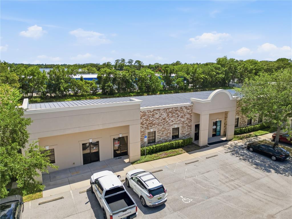 An exterior view of a single-story commercial building with a stone facade and parking lot — 4009 W 1ST STREET, SANFORD, FL