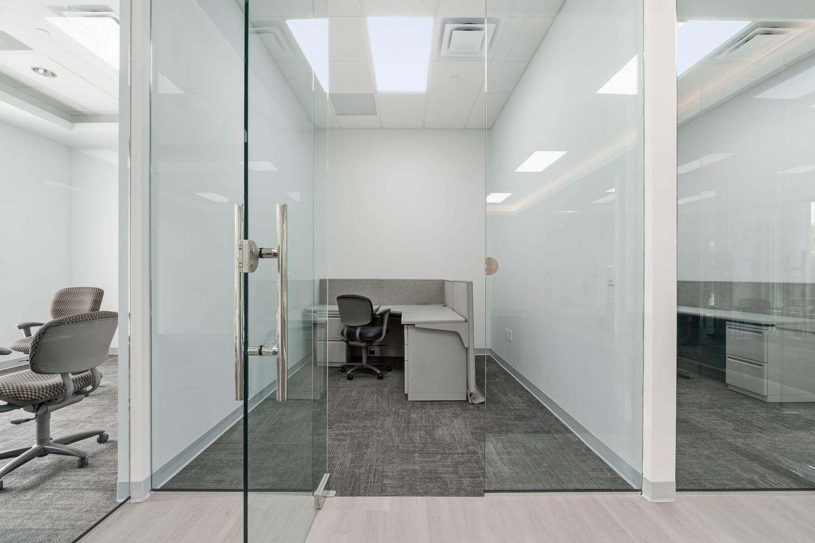 A modern office cubicle is enclosed within a glass-walled room featuring gray carpeted flooring — 1300 S Dixie Highway # 14, Lantana FL 33462, LANTANA, FL