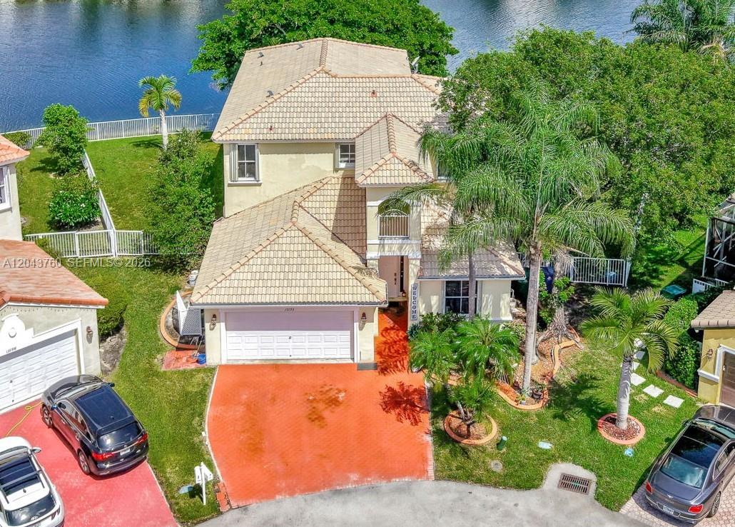 An aerial view of a two-story house with a tiled roof and a red driveway — 13193 SW 30th St, Miramar FL 33027, MIRAMAR, FL