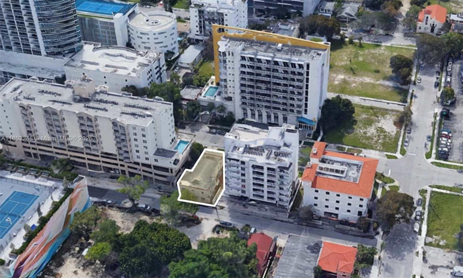 An aerial view shows a small, rectangular building highlighted in white amidst larger surrounding structures — 437 NE 30th St, Miami FL 33137, MIAMI, FL