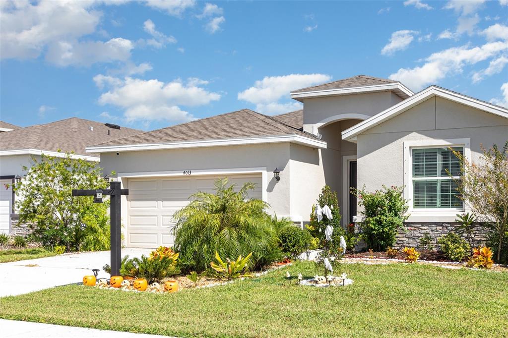 An aerial view shows a row of suburban houses overlooking a large marsh and waterway — 4013 LIVELY CORAL PLACE, BRADENTON, FL