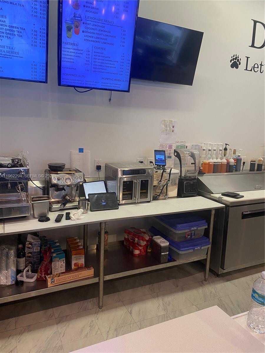 A commercial kitchen counter features espresso machines, a toaster oven, and a digital menu board — 8711 SW 124th Ave, Miami FL 33183, MIAMI, FL