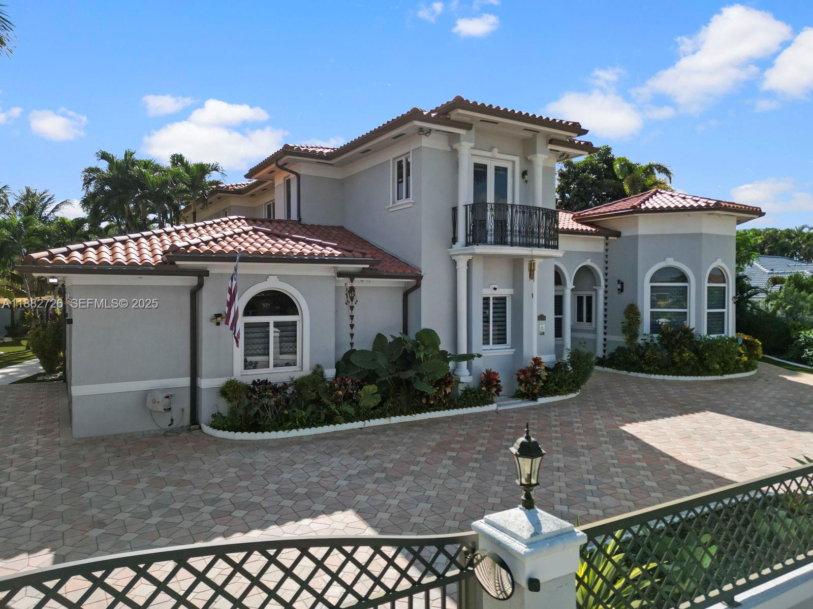 A two-story house with a tiled roof, gray stucco exterior, and a paved driveway — 12770 SW 188th St, Miami FL 33177, MIAMI, FL