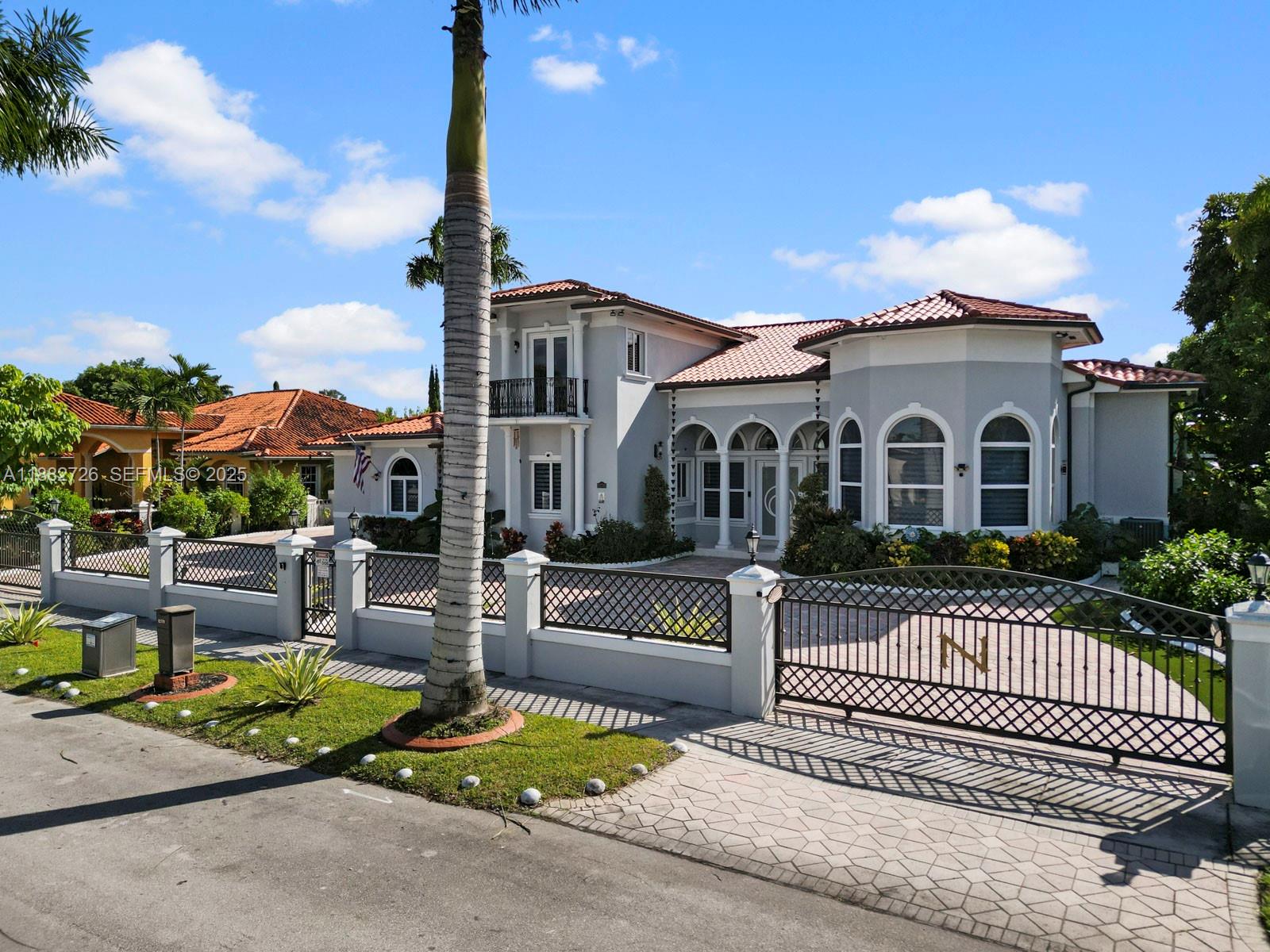 A two-story gray house with a tiled roof and a gated driveway — 12770 SW 188th St, Miami FL 33177, MIAMI, FL
