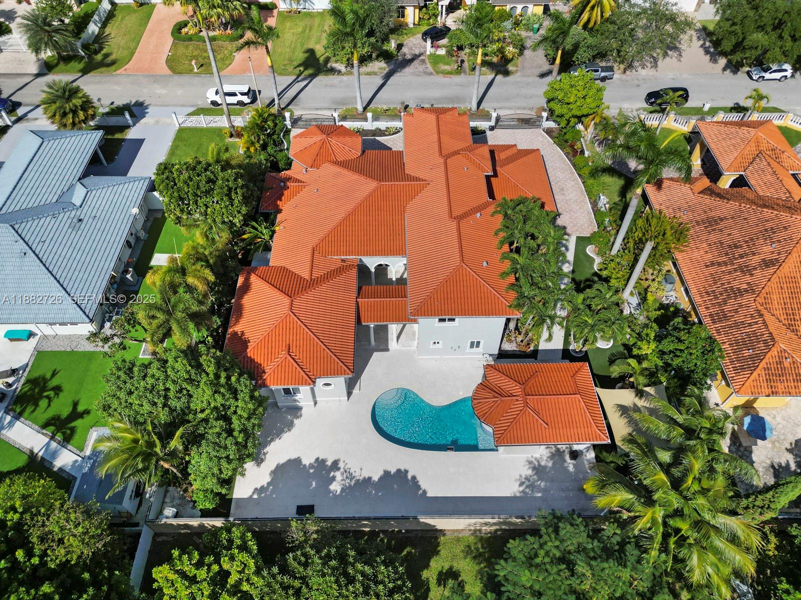 An aerial view shows a house with a red tile roof, pool, and surrounding landscaping — 12770 SW 188th St, Miami FL 33177, MIAMI, FL