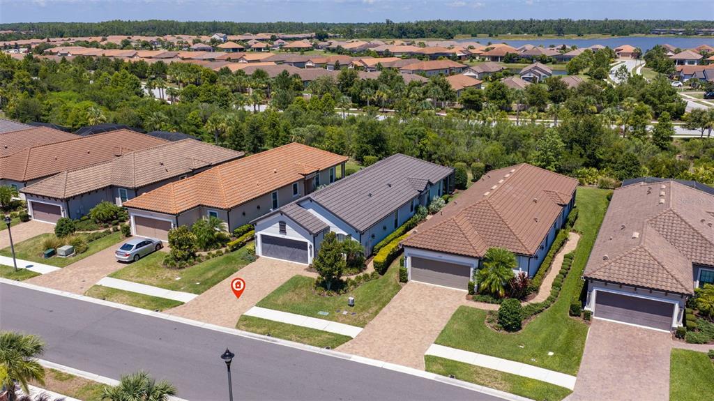 An aerial view shows a row of suburban houses with tiled roofs and paved driveways — 3254 FRANCOA DRIVE, ODESSA, FL