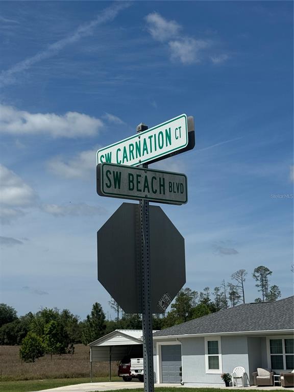 A street sign at the intersection of SW Carnation Ct and SW Beach Blvd — SW BEACH BOULEVARD, DUNNELLON, FL