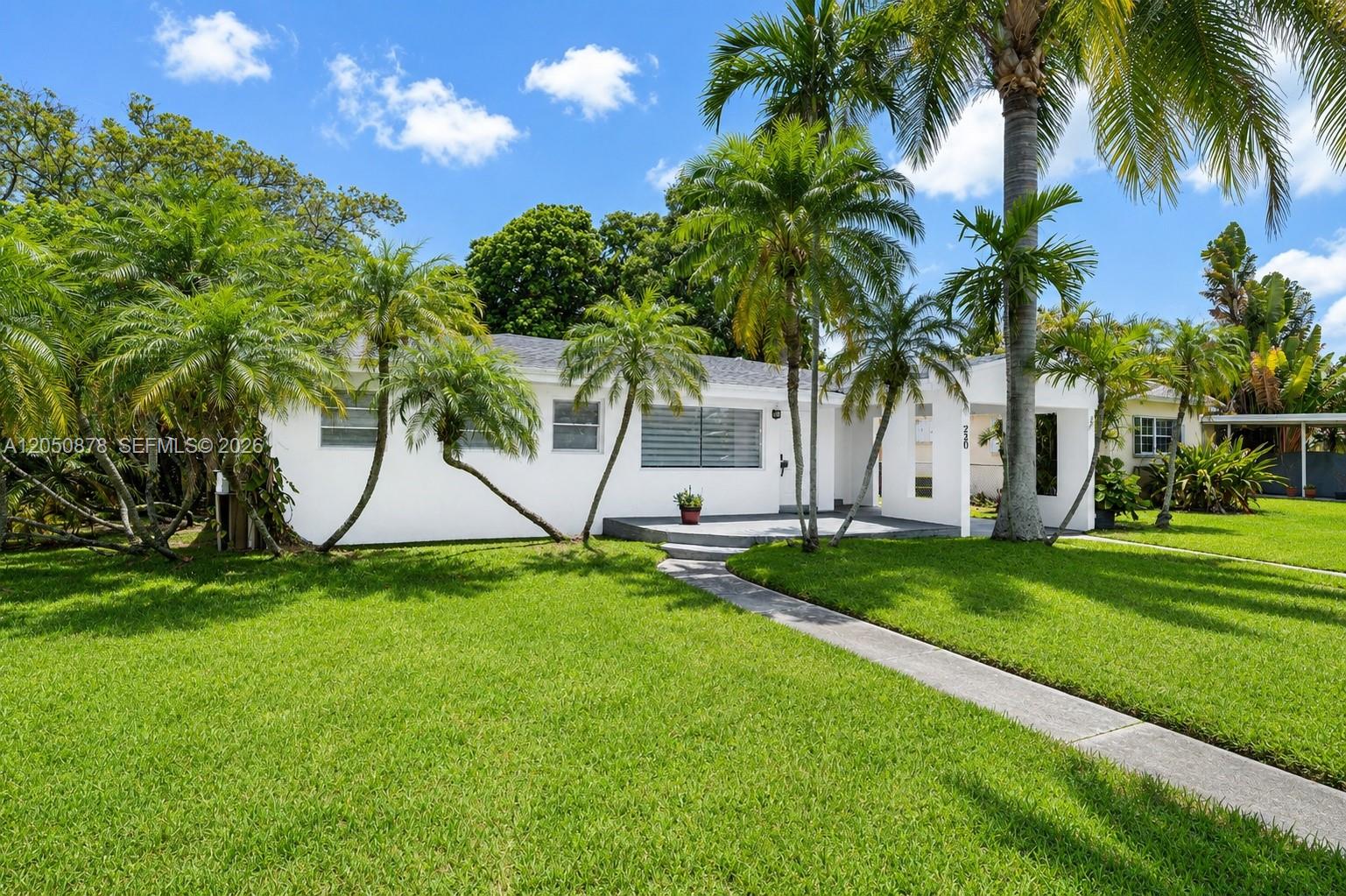 A white single-story house with a front lawn, palm trees, and a concrete walkway — 230 NE 2nd Pl, Dania Beach FL 33004, DANIA BEACH, FL