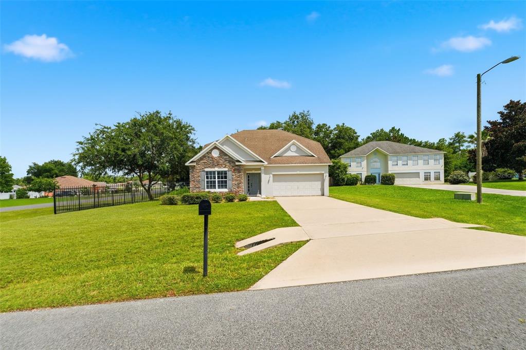 A single-story house with a stone facade, a two-car garage, and a concrete driveway — 11661 SW 56TH TERRACE, OCALA, FL
