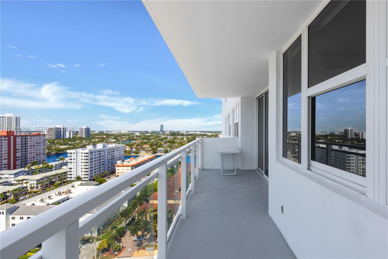 A high-rise balcony features a glass railing, gray flooring, and an expansive city view — 2030 S Ocean Dr # 1708, Hallandale Beach FL 33009, HALLANDALE BEACH, FL