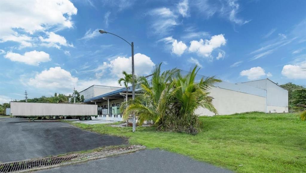 A large industrial warehouse building with a loading dock and a parked semi-trailer — Calle 2 PR-7731 INT PR 171, CIDRA, PR