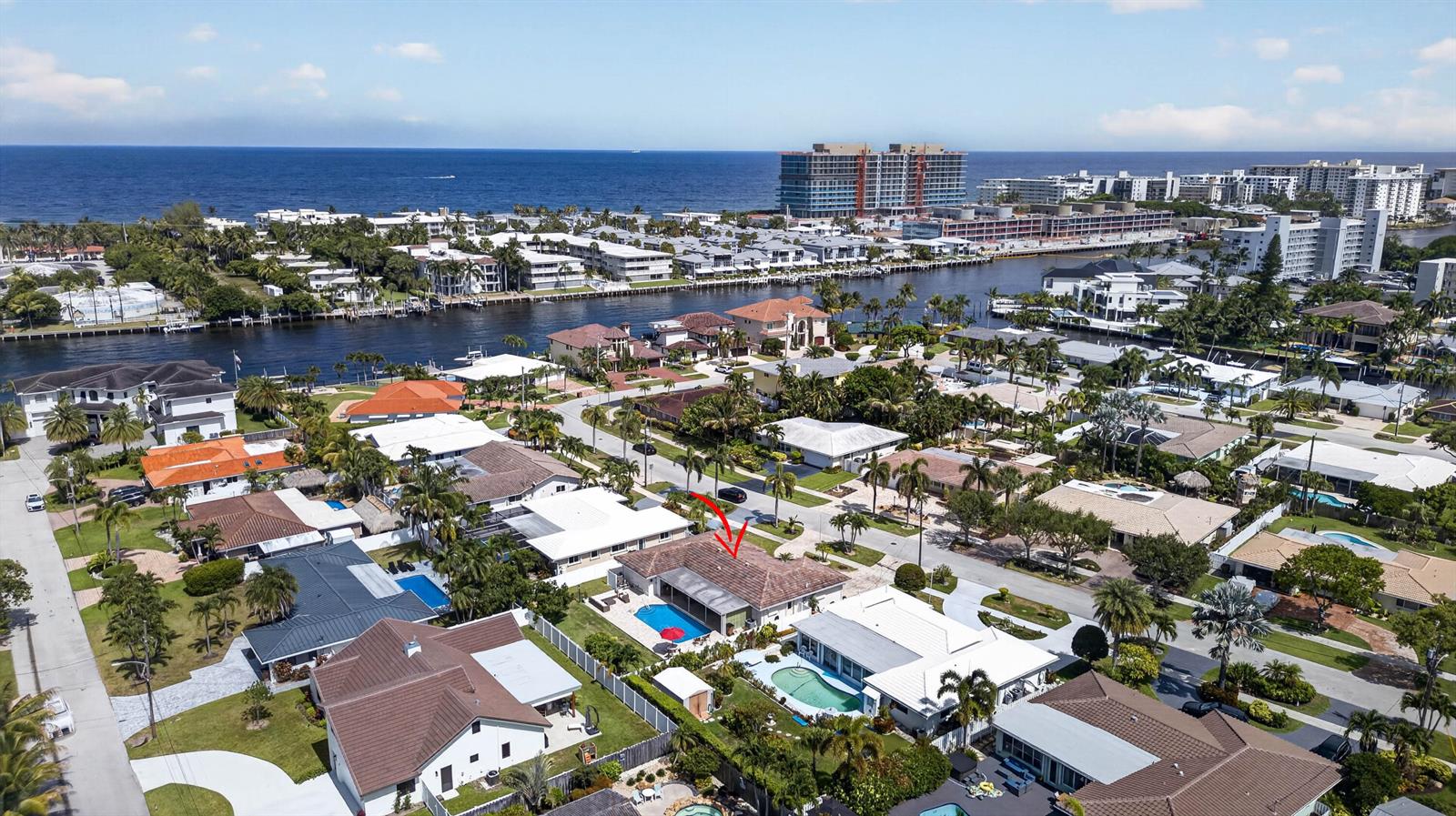 An aerial view shows a residential neighborhood with houses, swimming pools, and a nearby waterway — 1517 SE 14TH Street, Deerfield Beach FL 33441, DEERFIELD BEACH, FL