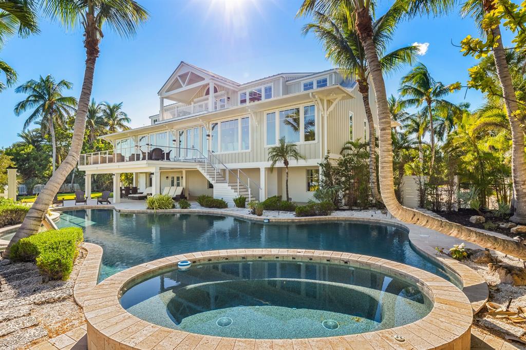 A multi-story house with a pool and hot tub surrounded by palm trees — 4070 LOOMIS AVENUE, BOCA GRANDE, FL