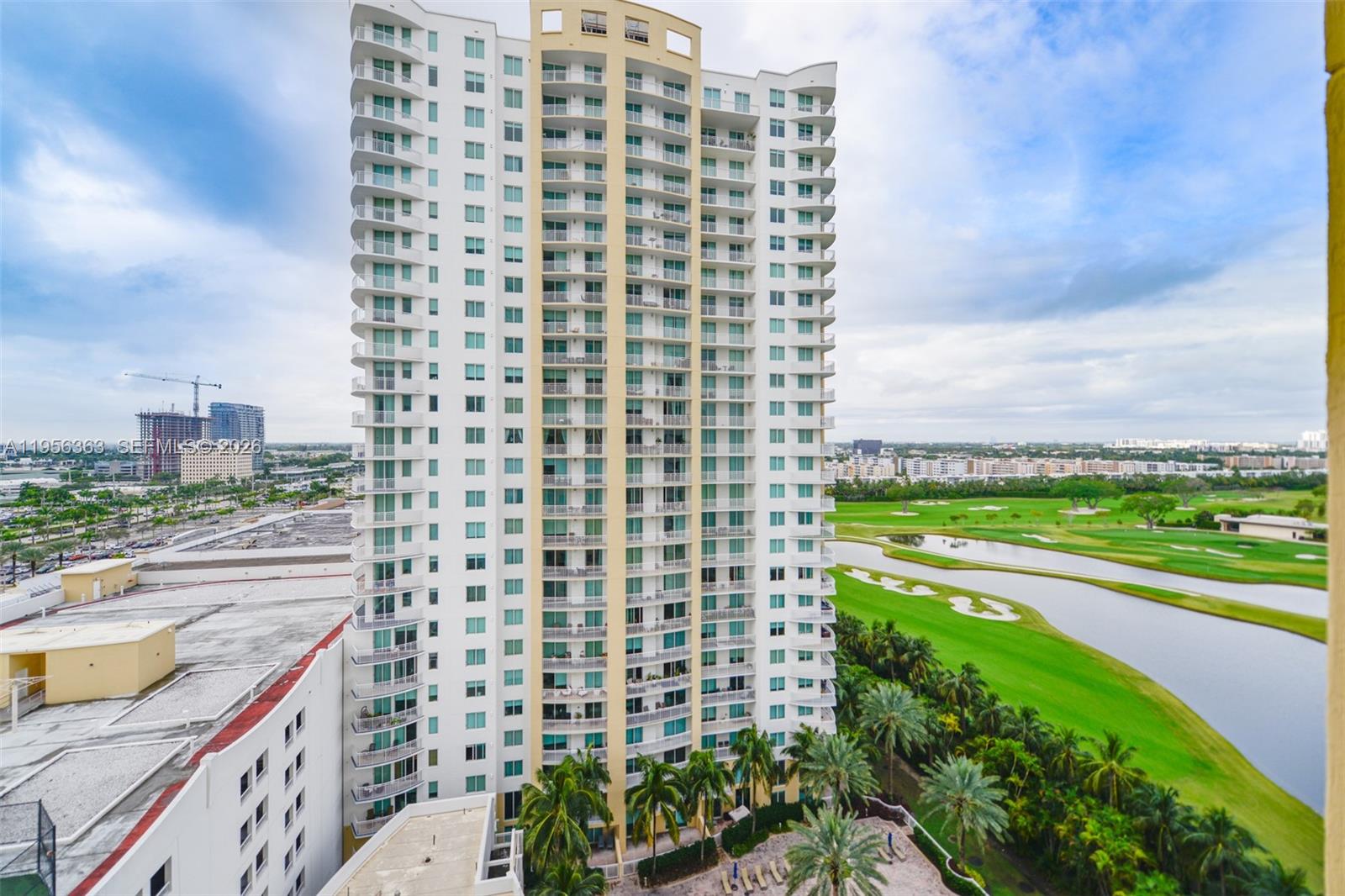 A tall residential high-rise building stands next to a golf course and a lake — 1755 E Hallandale Beach Blvd # 1408E, Hallandale Beach FL 33009, HALLANDALE BEACH, FL