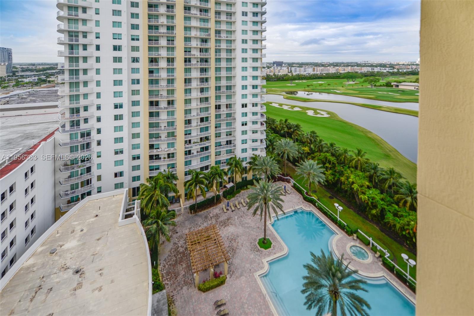 An elevated view shows a high-rise building, a swimming pool, and a golf course — 1755 E Hallandale Beach Blvd # 1408E, Hallandale Beach FL 33009, HALLANDALE BEACH, FL