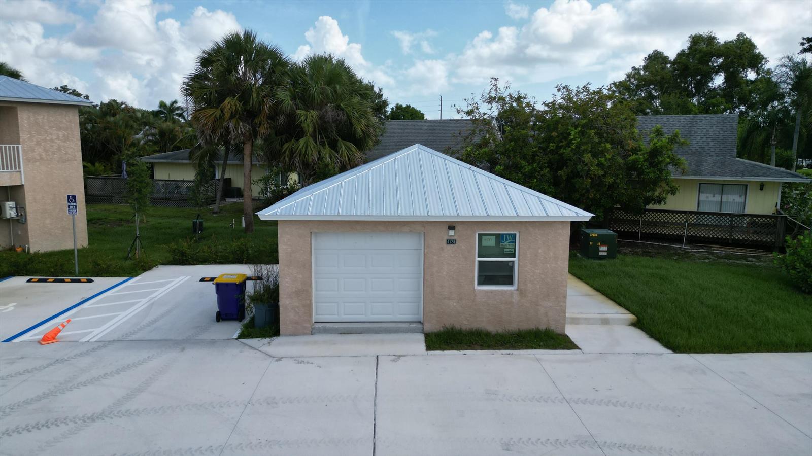A detached single-car garage with a metal roof and stucco exterior sits on a concrete lot — 0 SE Morningside Drive, FL 34997, FL