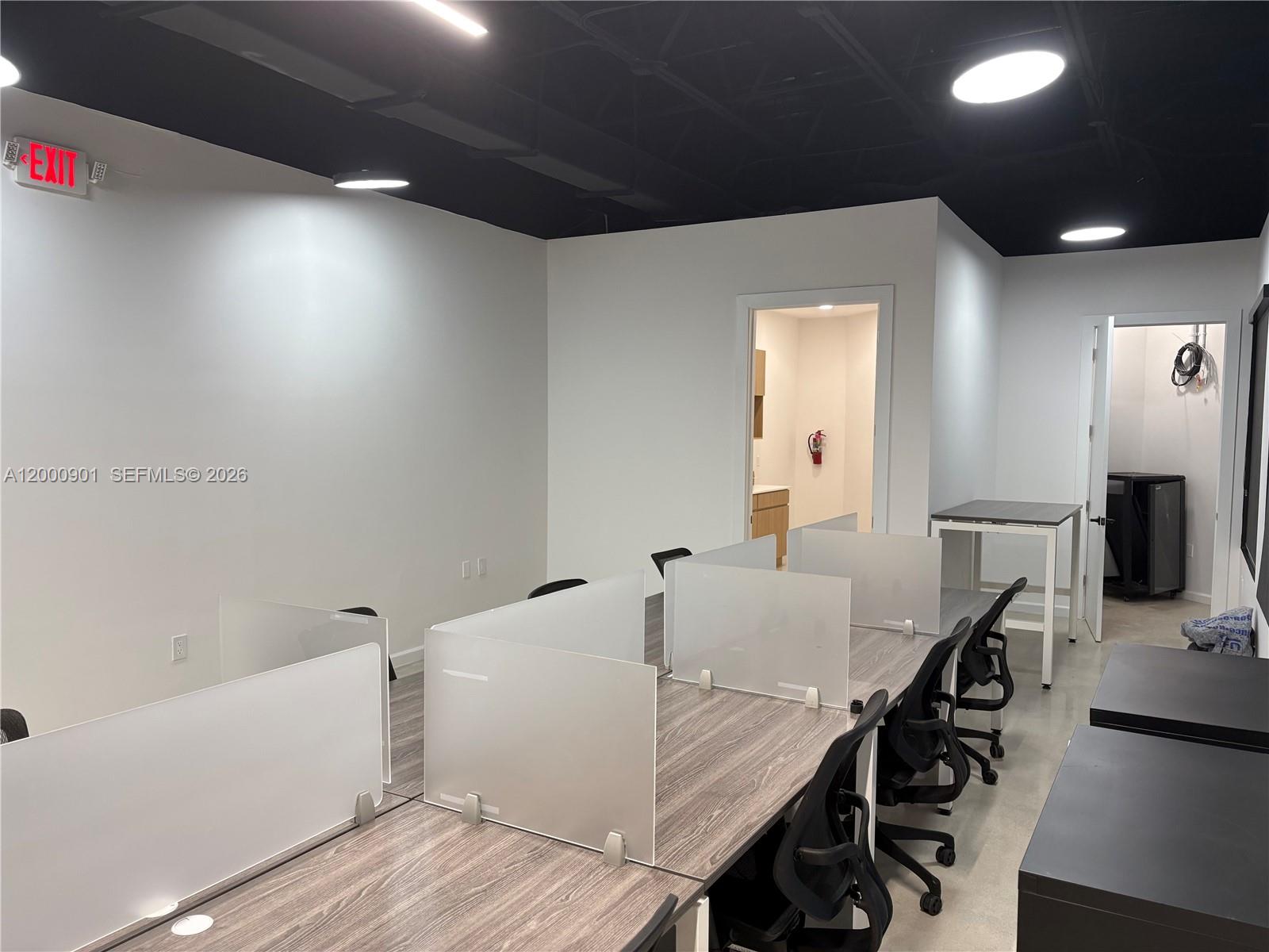 An office space features rows of desks with privacy dividers, black ceilings, and white walls — 1545 N Park Dr, Weston FL 33326, WESTON, FL