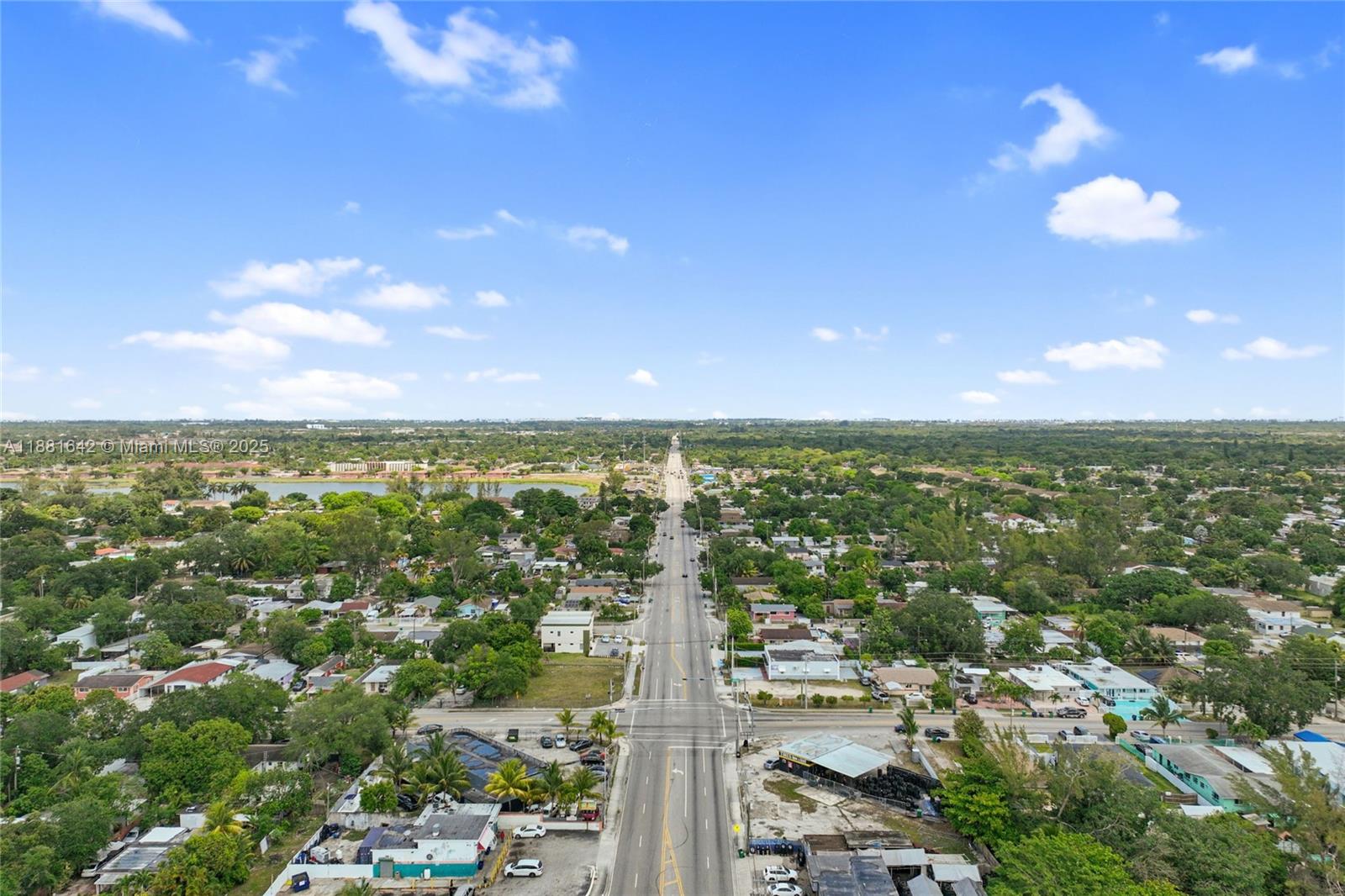 An aerial view shows a straight road running through a suburban neighborhood with green trees — 11070 NW 17th Ave, Miami FL 33167, MIAMI, FL