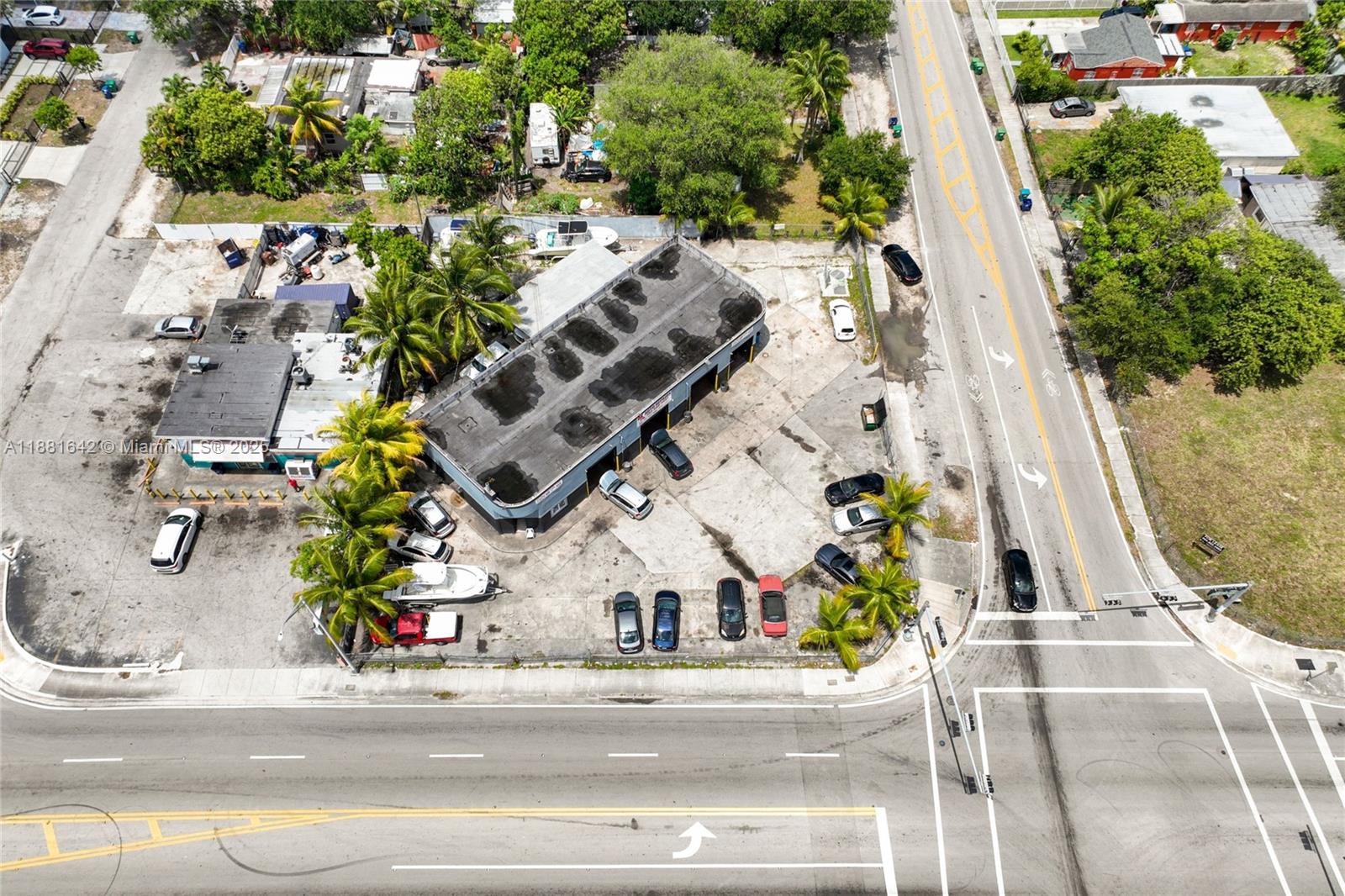 An aerial view shows a commercial building with a parking lot at a street intersection — 11070 NW 17th Ave, Miami FL 33167, MIAMI, FL