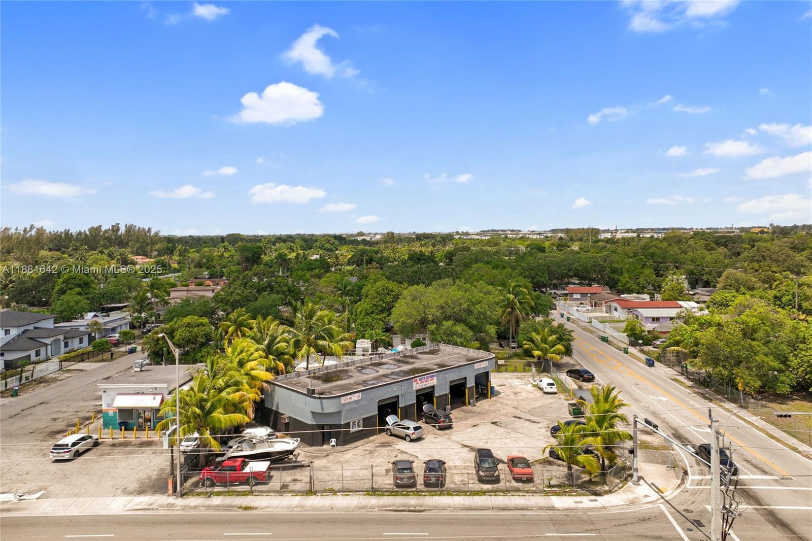 An aerial view shows an auto repair shop with a parking lot and surrounding neighborhood — 11070 NW 17th Ave, Miami FL 33167, MIAMI, FL