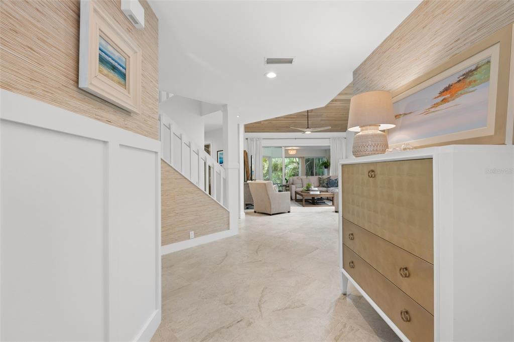 A bright entryway features textured wallpaper, a white chest of drawers, and tile flooring — 264 WOODS POINT ROAD, OSPREY, FL