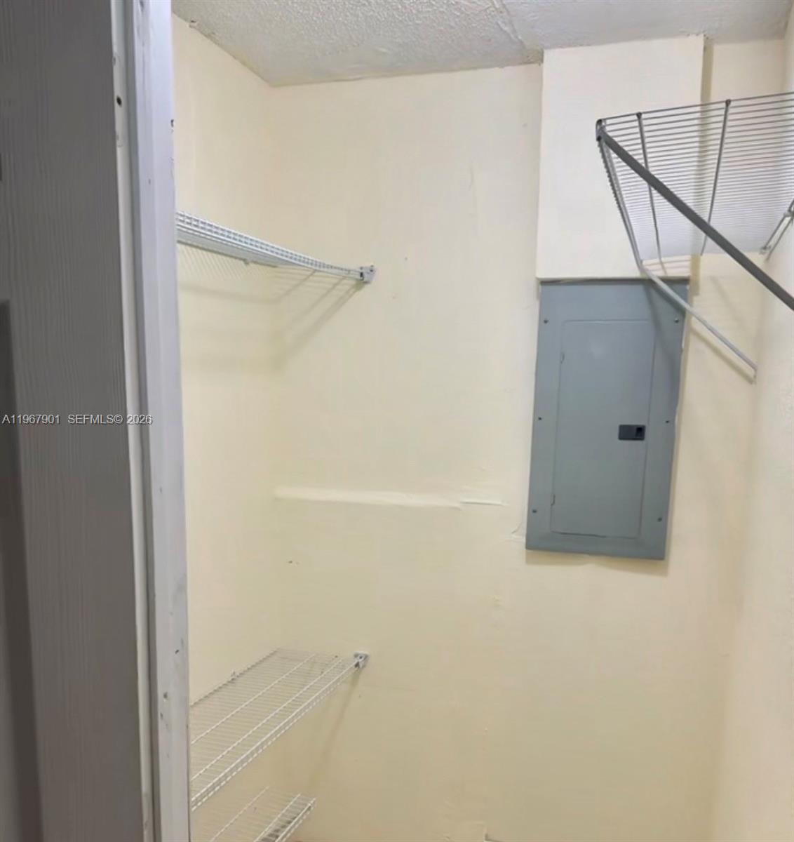 A small closet features wire shelving and an electrical breaker panel on the wall — 103xx SW 168th St # 0, Miami FL 33157, MIAMI, FL