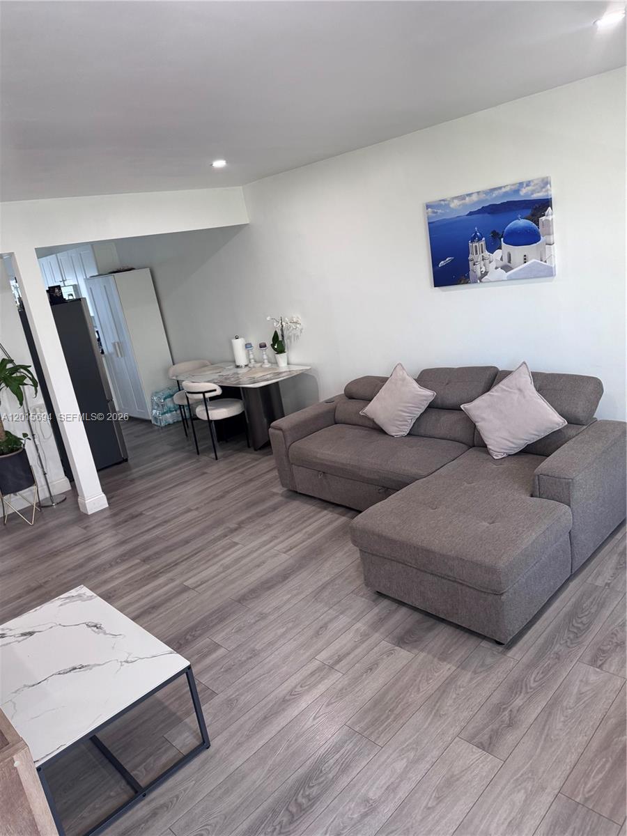 An outdoor swimming pool is surrounded by a metal fence and lounge chairs — 8550 Byron Ave # 2G, Miami Beach FL 33141, MIAMI BEACH, FL