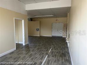 An interior view of a commercial space with light-colored walls and gray wood-look flooring — 104 US 27 HIGHWAY S, AVON PARK, FL