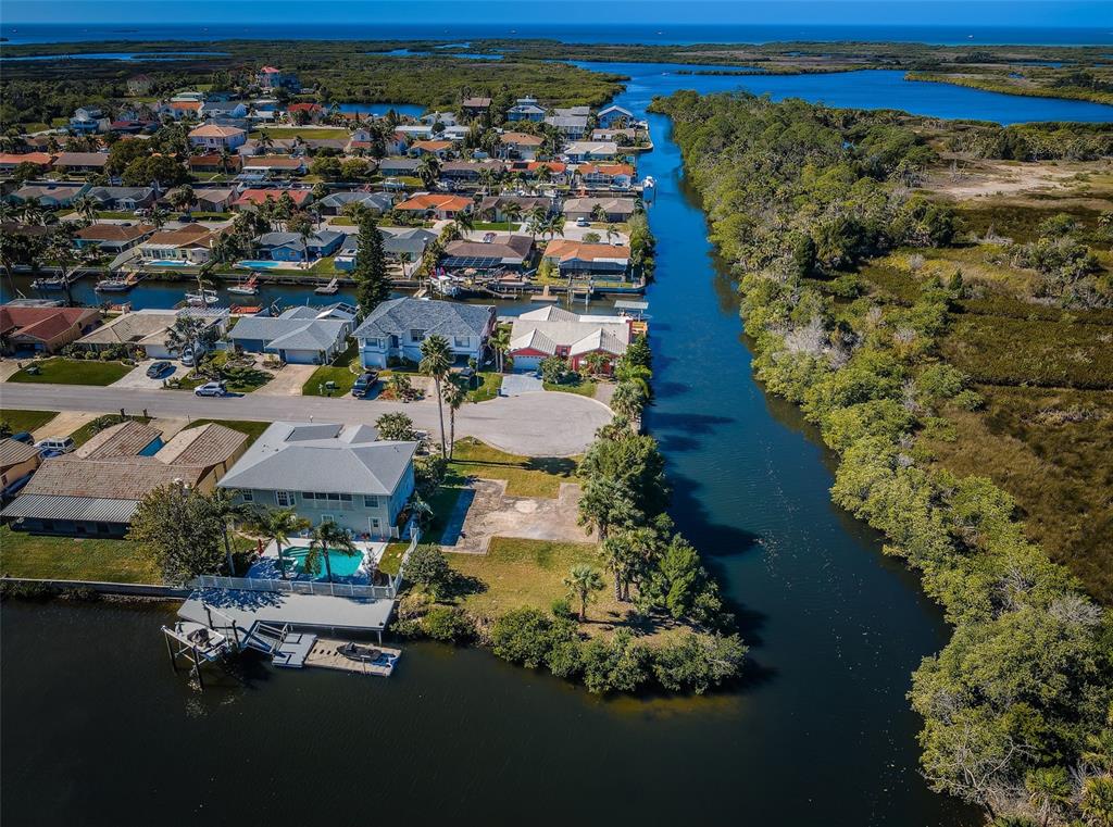 An aerial view shows a waterfront house with a pool next to a canal — 0 SAN SIERRA WAY, PORT RICHEY, FL