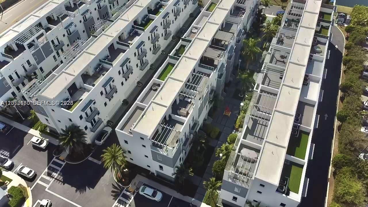 An aerial view shows several rows of modern multi-story townhouses with flat roofs and balconies — 9151 NW 33rd St, Doral FL 33172, DORAL, FL