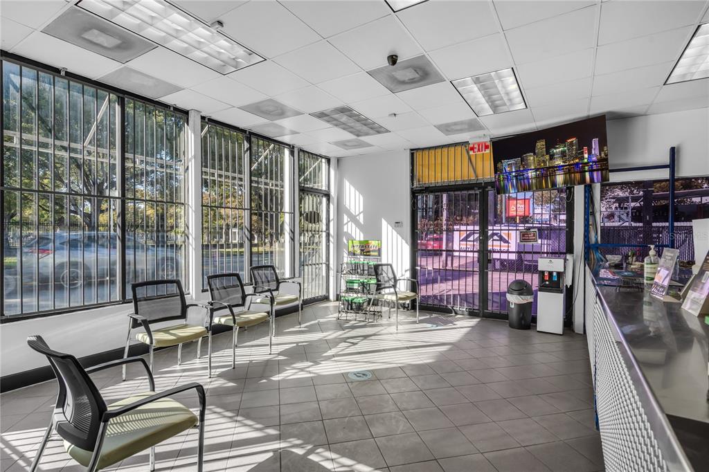 A commercial waiting area features tiled floors, large windows with security bars, and several chairs — 3219 SW 8TH STREET, MIAMI, FL