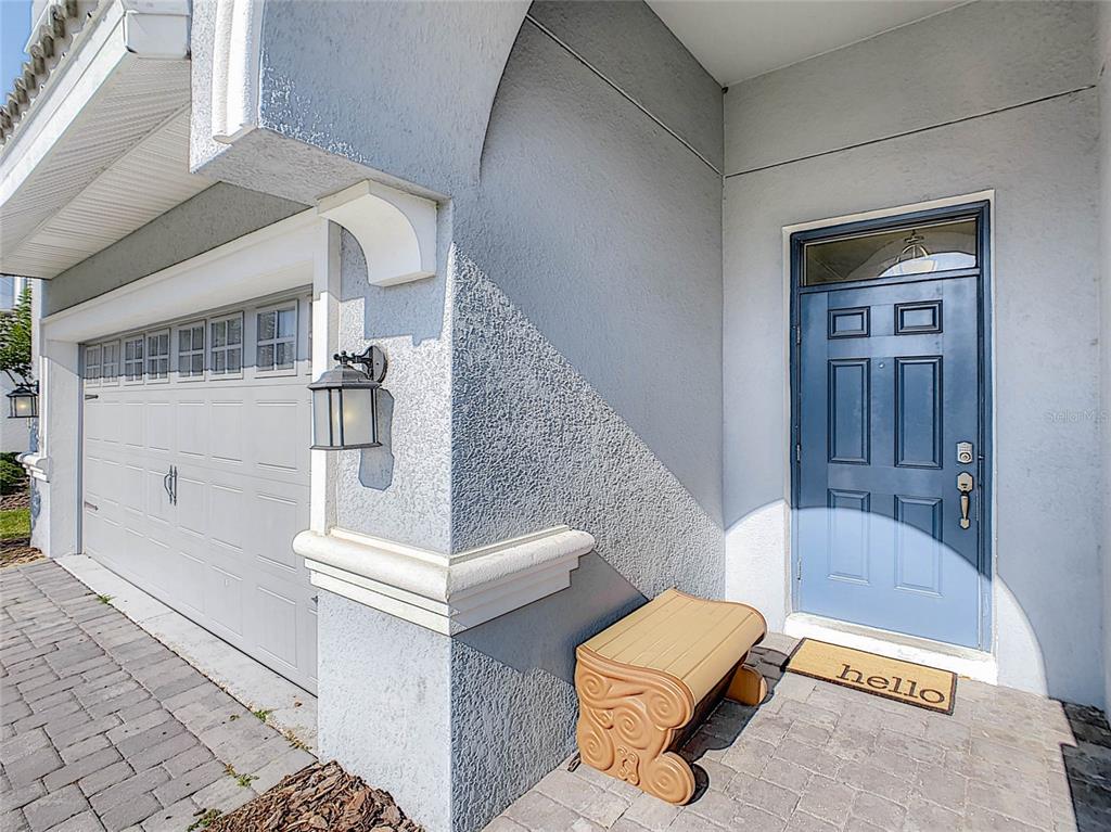 A blue front door and a garage are visible on the exterior of a house — 9095 HAZARD STREET, DAVENPORT, FL