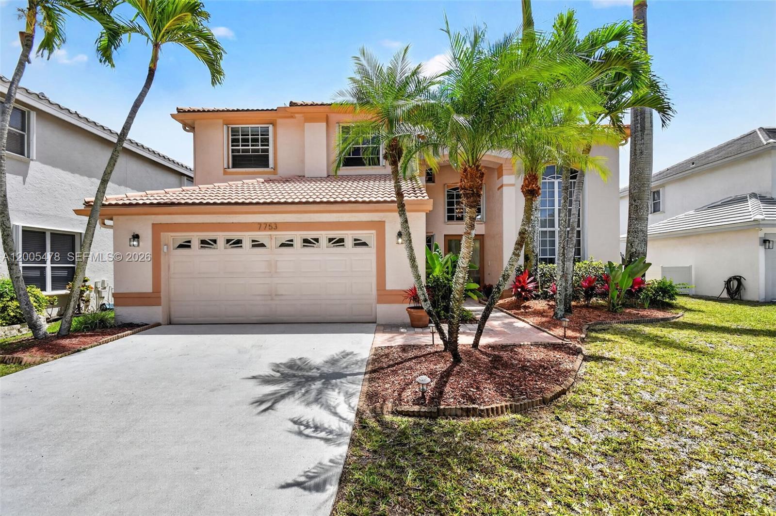 A two-story house with a beige stucco exterior, a tile roof, and a front garage — 7753 Cedar Hurst Ct, Lake Worth FL 33467, LAKE WORTH, FL