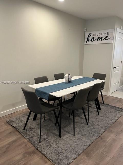 A dining room features a white table with a blue runner, six gray chairs, and a rug — 1247 S Newkirk, PA 19146, PA