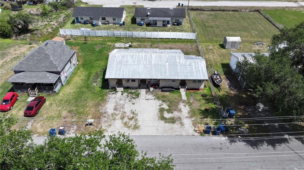 An aerial view shows a residential property with a duplex, a house, and parking areas — 32 N PALMETTO AVENUE, FORT MEADE, FL