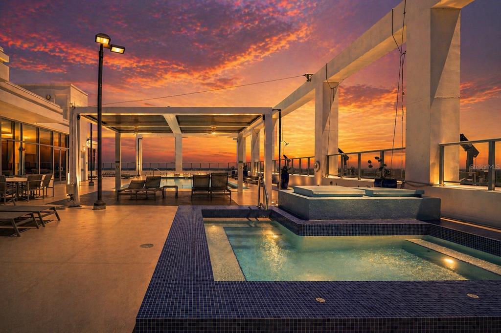 A rooftop terrace features a tiled hot tub, lounge chairs, and a covered seating area — 260 S OSCEOLA AVENUE UNIT 1005, ORLANDO, FL