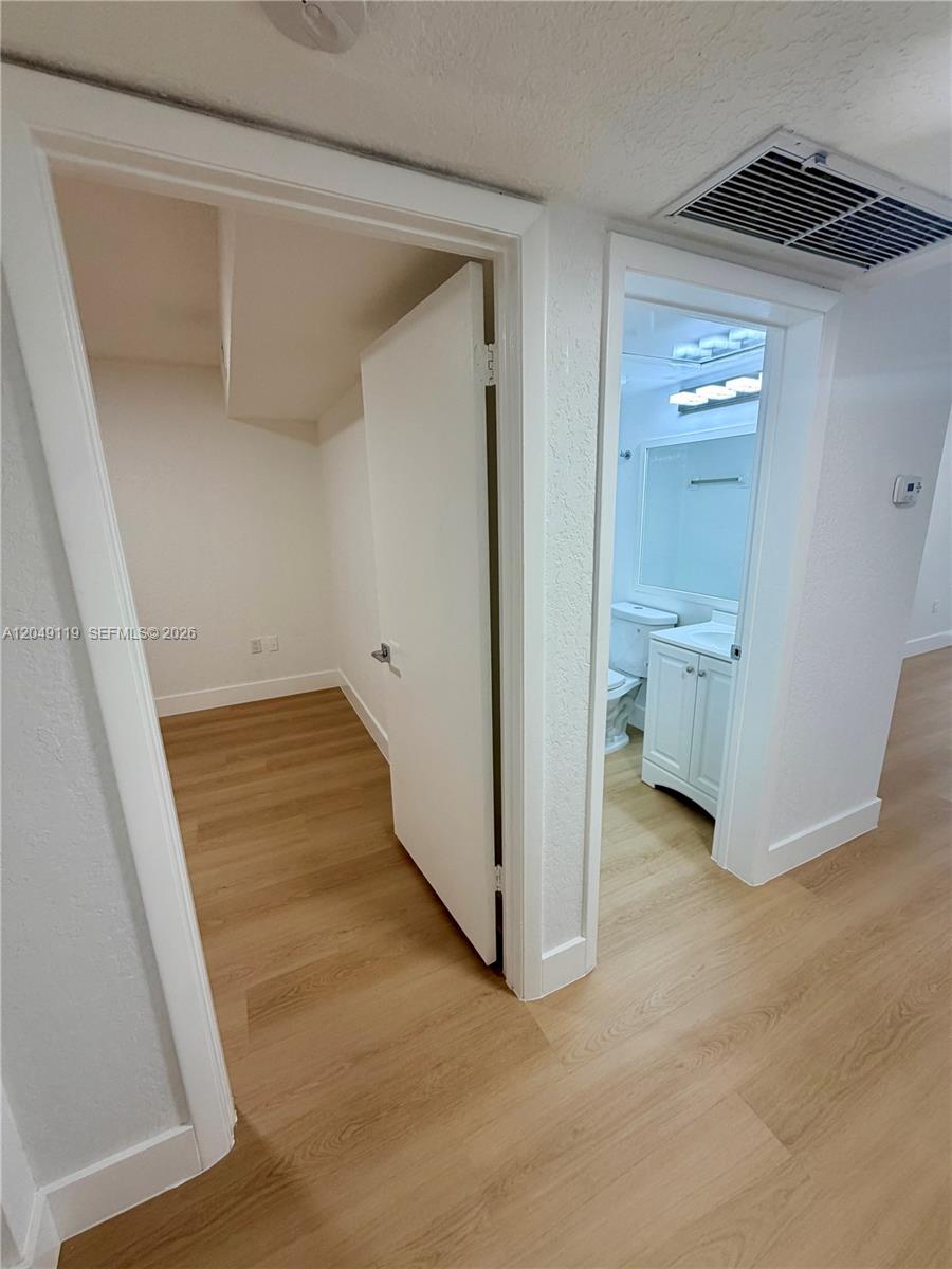 A view shows a doorway leading to a closet and an adjacent bathroom doorway — OAKLAND PARK, FL
