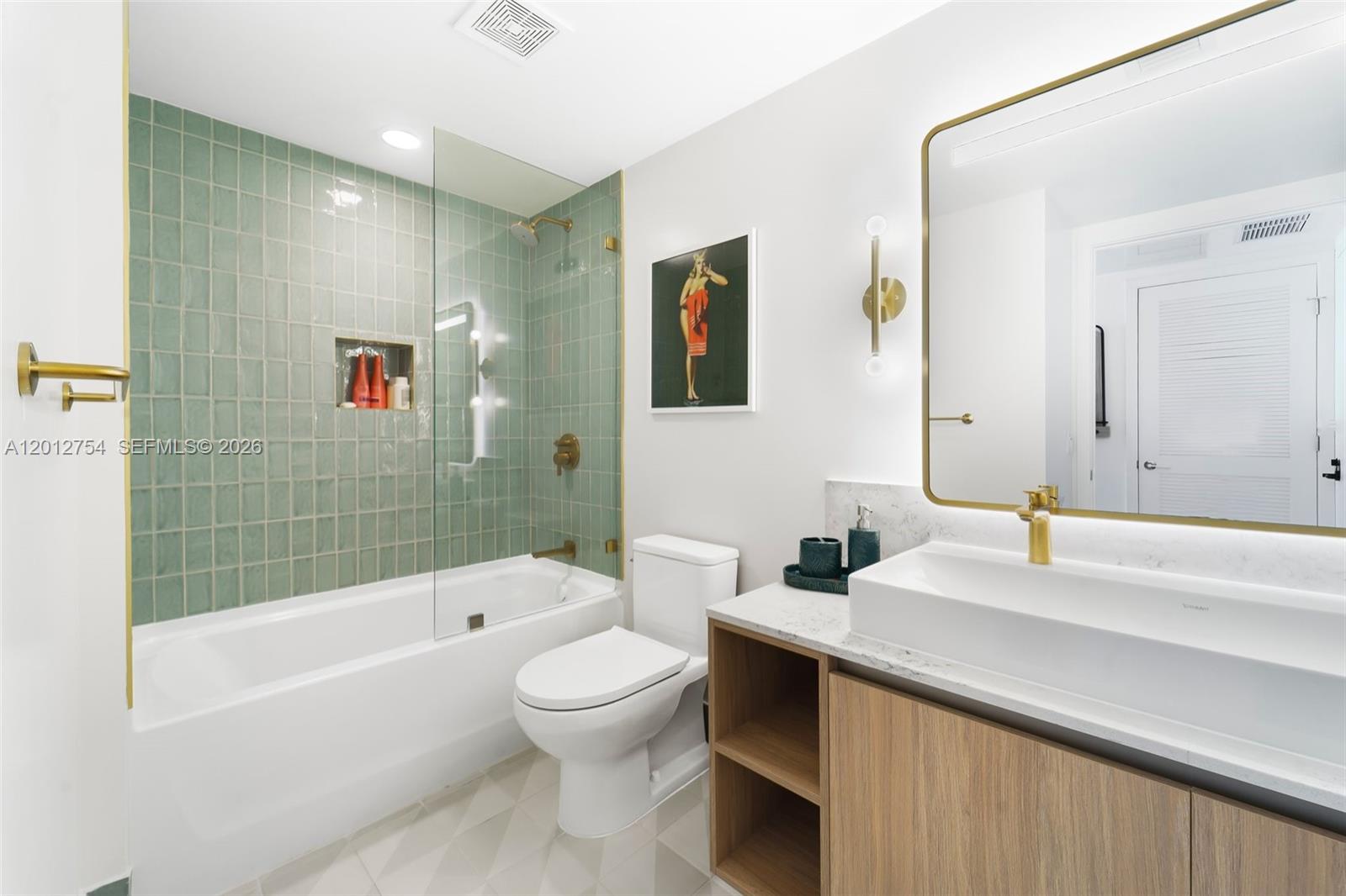 A modern bathroom features a green tiled shower, a white vanity, and gold-toned fixtures — 601 NE 1st Ave # 3210, Miami FL 33132, MIAMI, FL